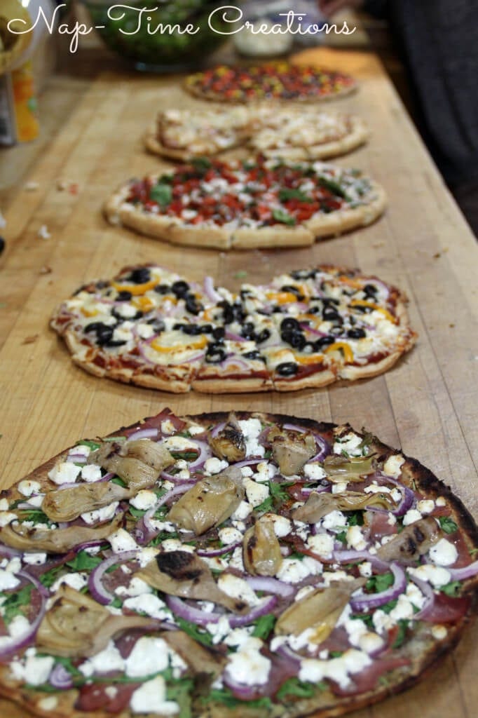 Family Pizza night recipes. Five pizzas on a counter top.