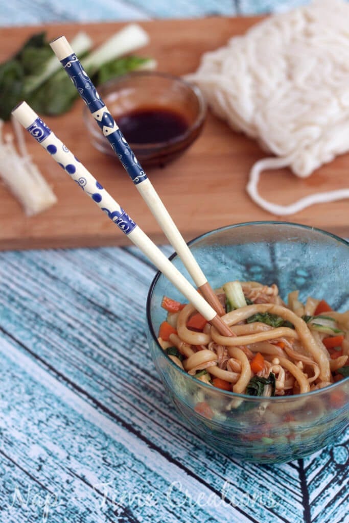 Dinner in a bowl with a pair of chopsticks.