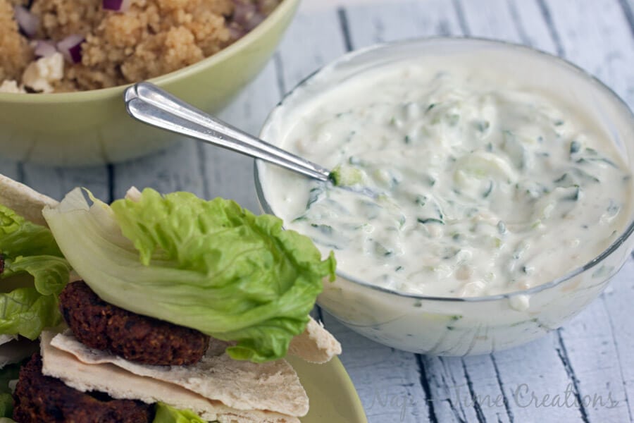 Greek Tzatziki Dip Recipe in a bowl with a spoon and lettuce.
